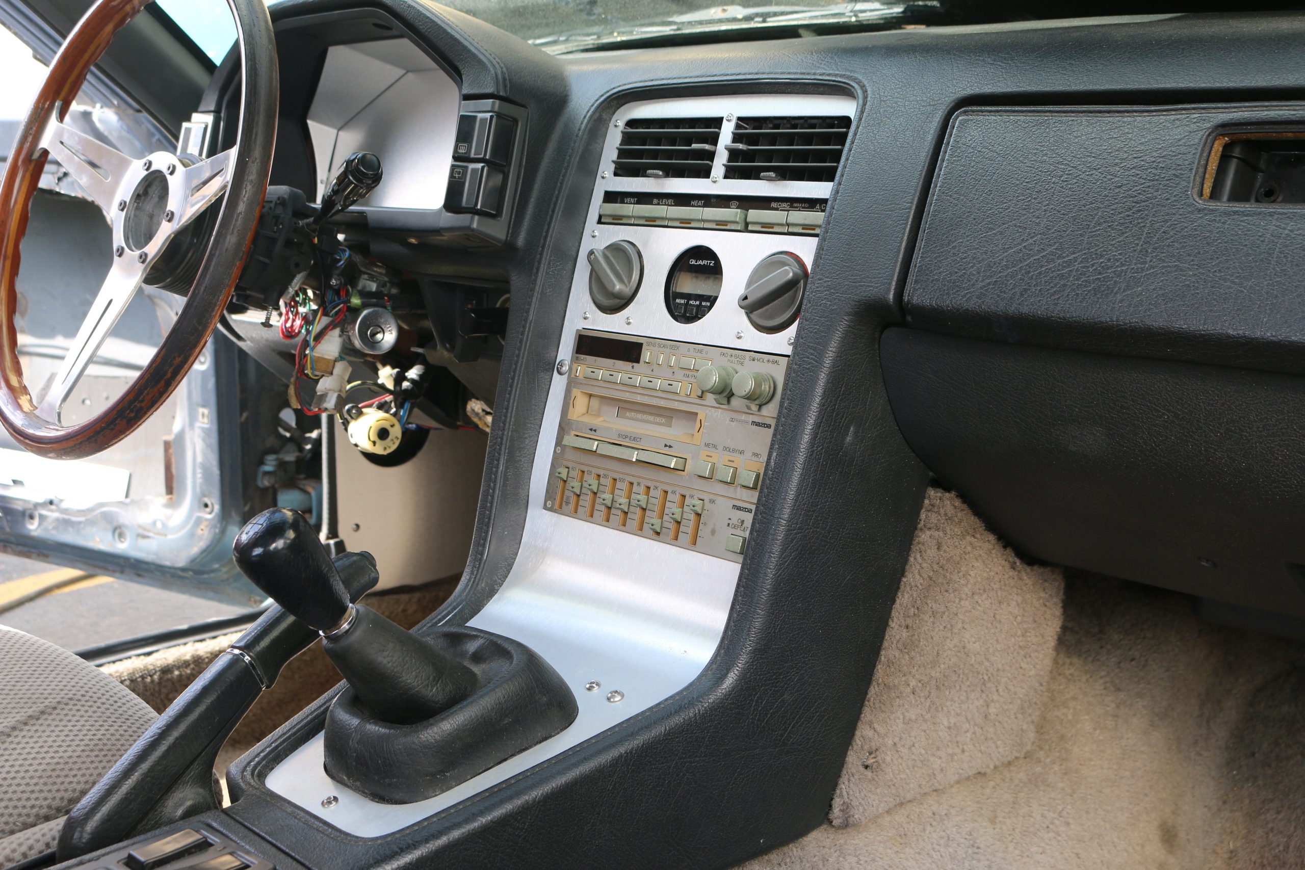 thumbnail interactive-video image 1 of Double Din Radio Bezel For Mazda RX-7 FC (1989-1992 S5) – Black Plastic – Made In Japan 1 of 2